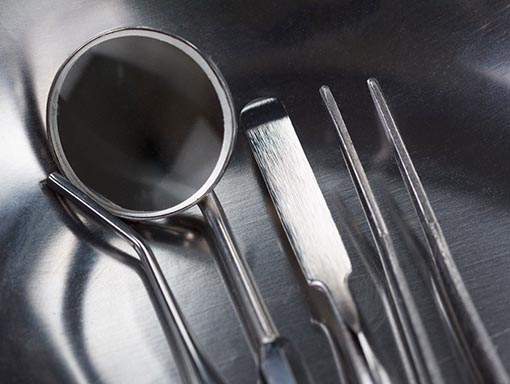 closeup of dental tools | Pollock Advanced Dental Group happy girl smiling comfortably